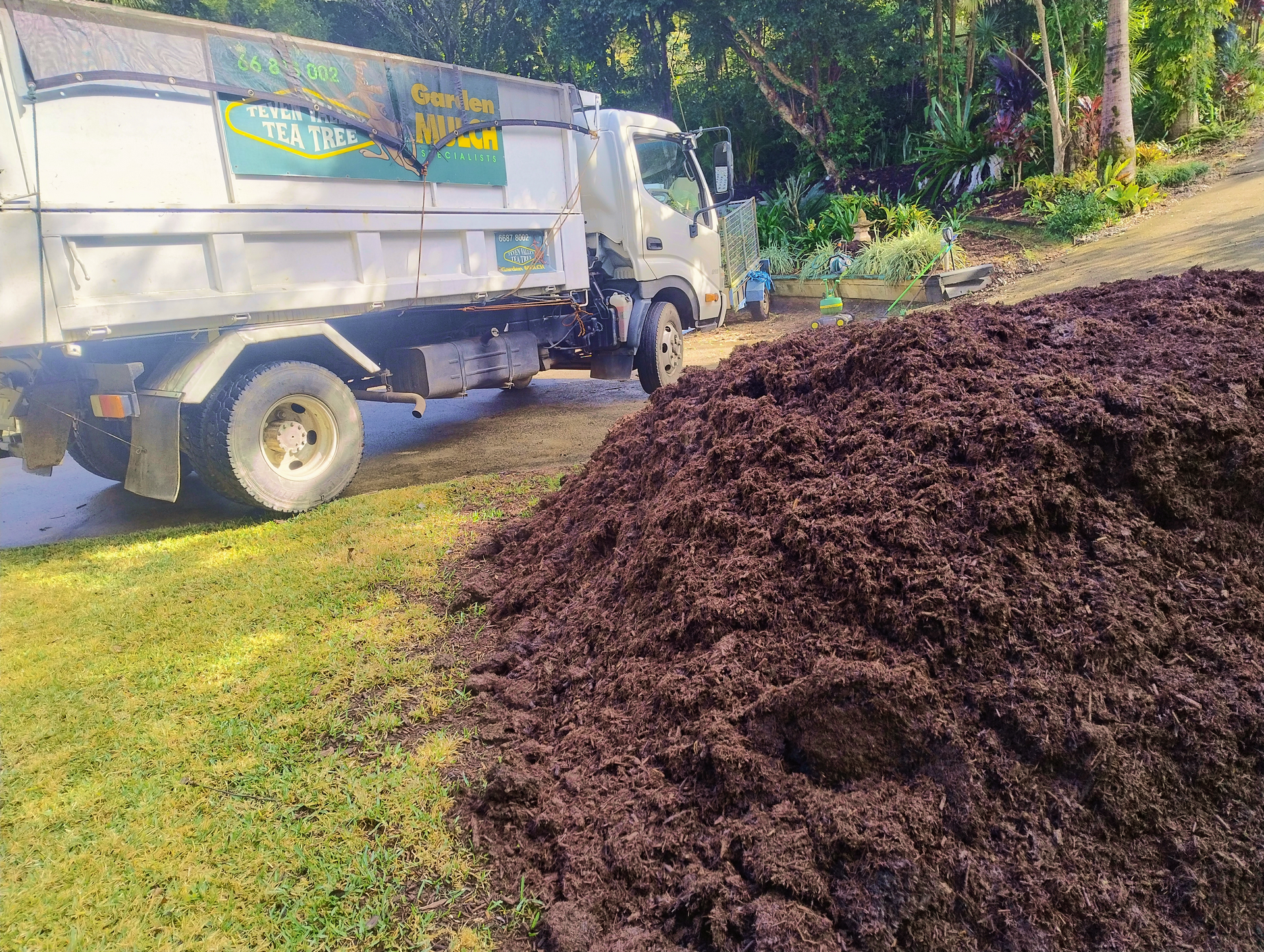 A White Truck Next to Mound of Fresh Tea Tree Mulch — Teven Valley Tea Tree Mulch In Ballina, NSW
