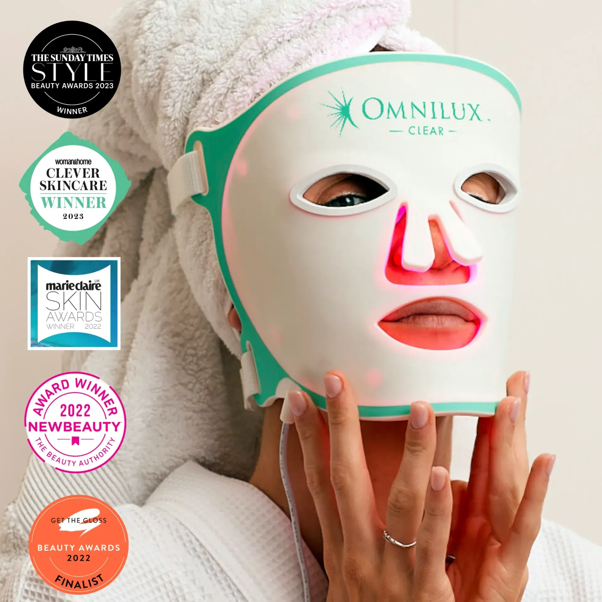 A green and pink led mask is sitting on a white surface.