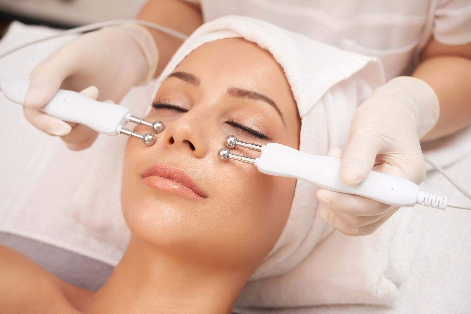 A woman is getting a facial treatment at a beauty salon.