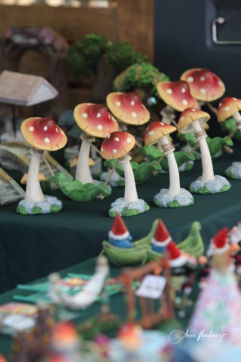A table with a bunch of mushrooms and gnomes on it