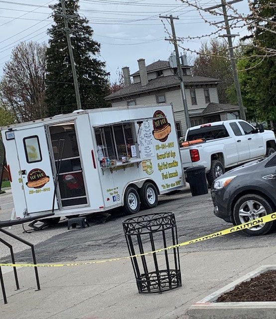 A food truck is parked on the side of the road