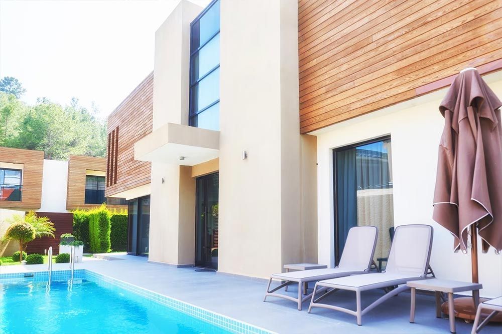 A large house with a swimming pool in front of it