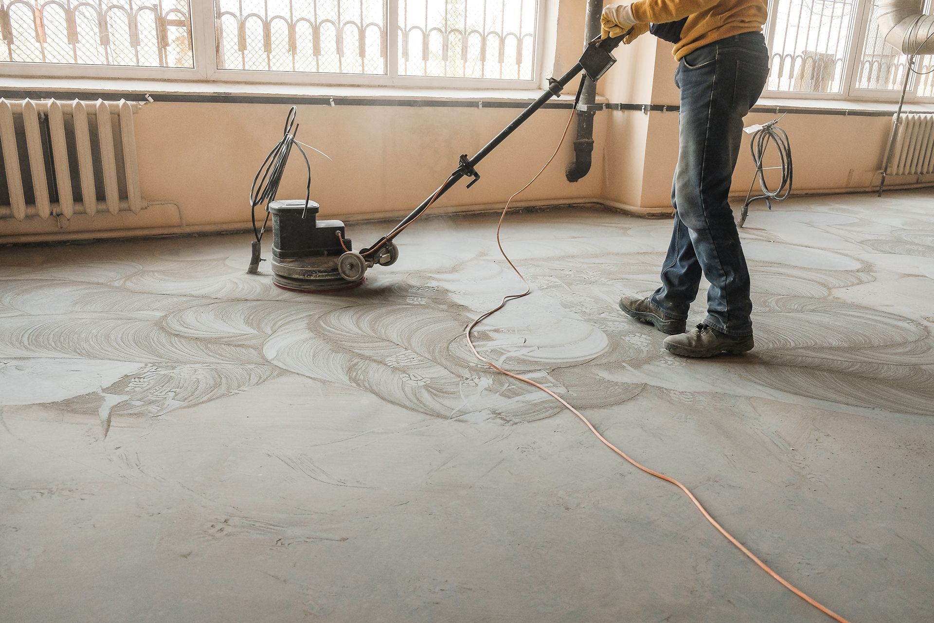 Workers grind the concrete floor on site for a smooth, durable finish. Workers grind the concrete floor on site for a smooth, durable finish.