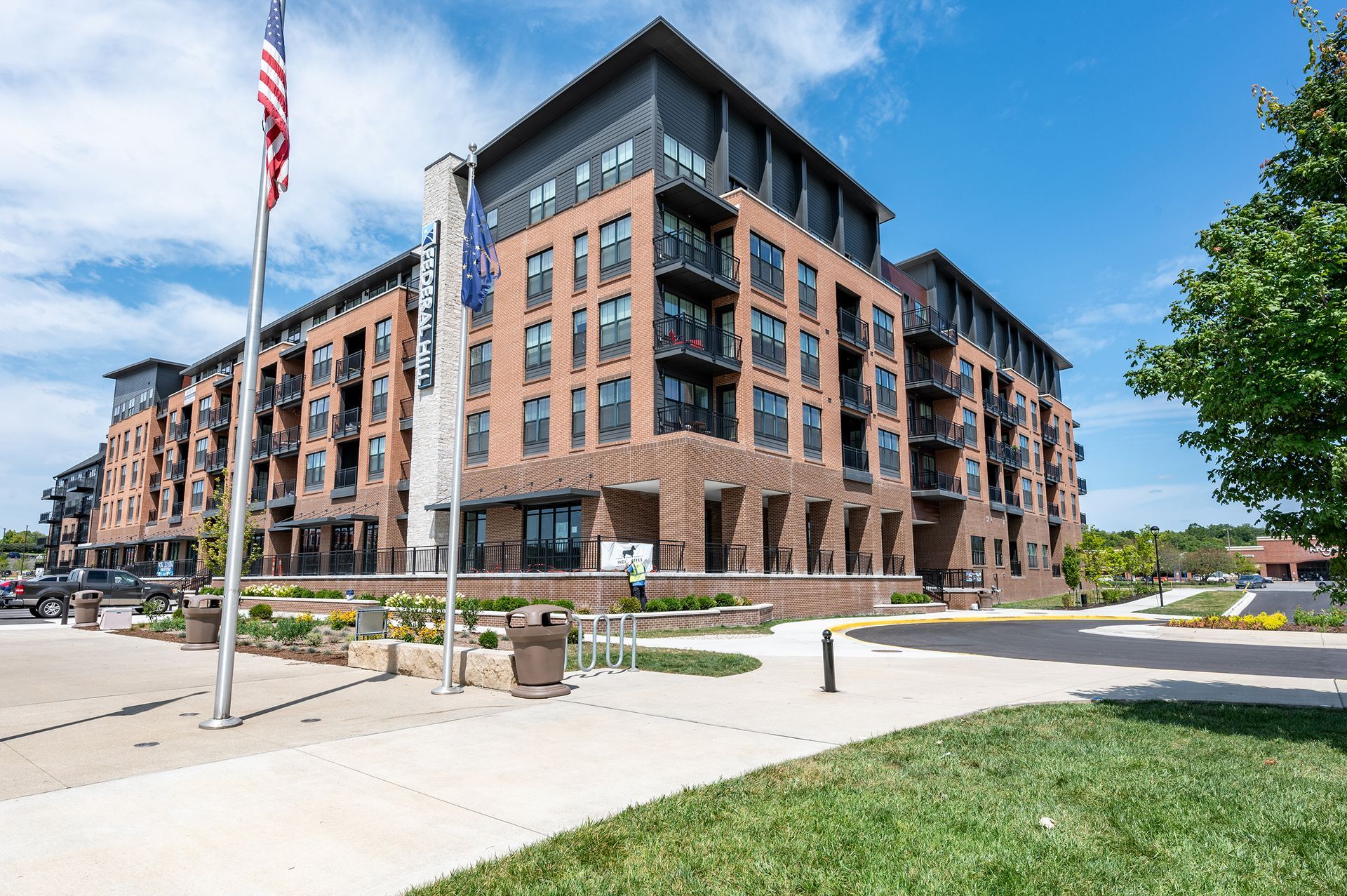 Exterior view of Federal Hill apartment building with green space in Noblesville, IN.