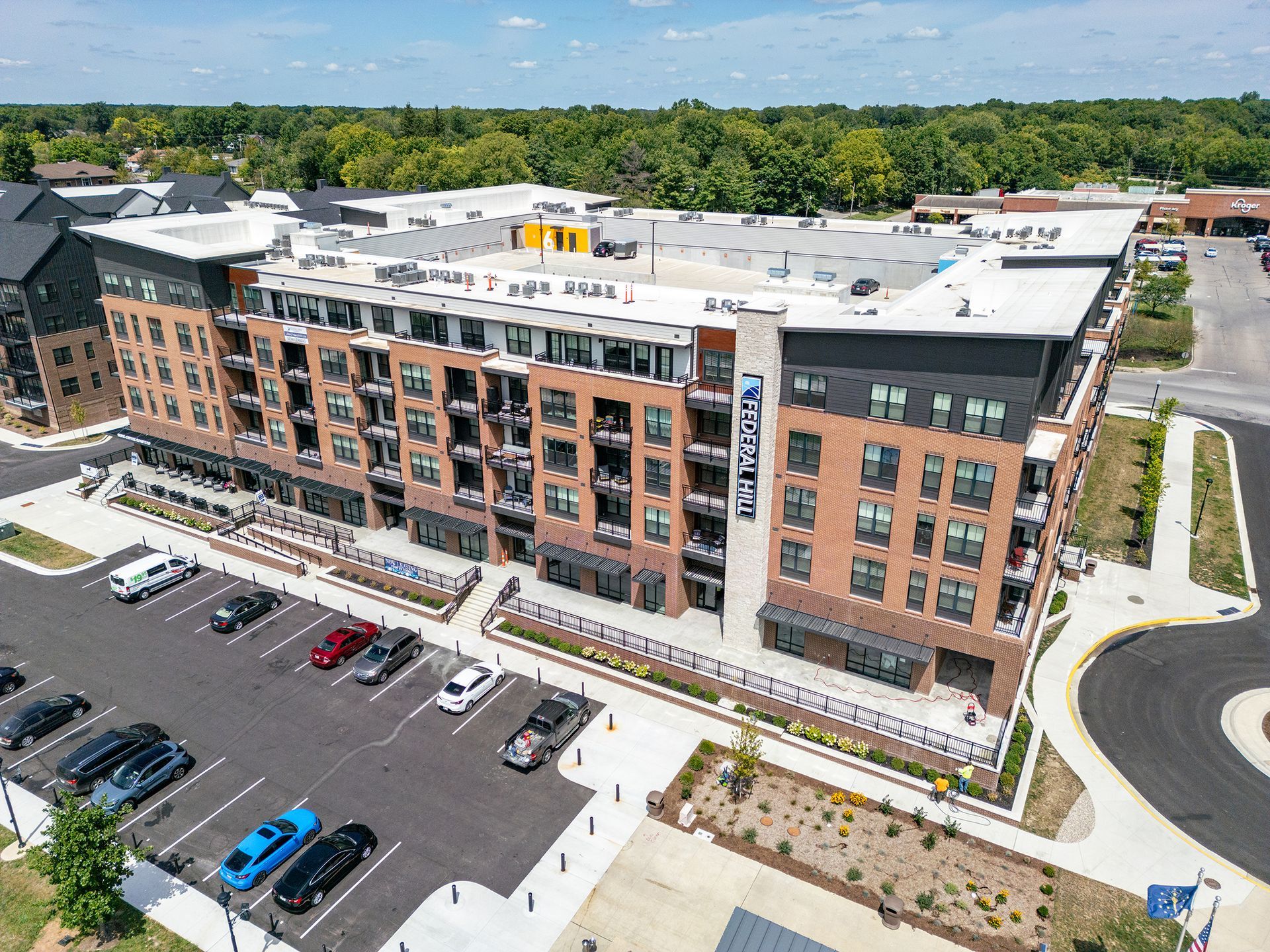 An aerial view of a large apartment building with a parking lot in front of it at Federal Hill in Noblesville, IN.