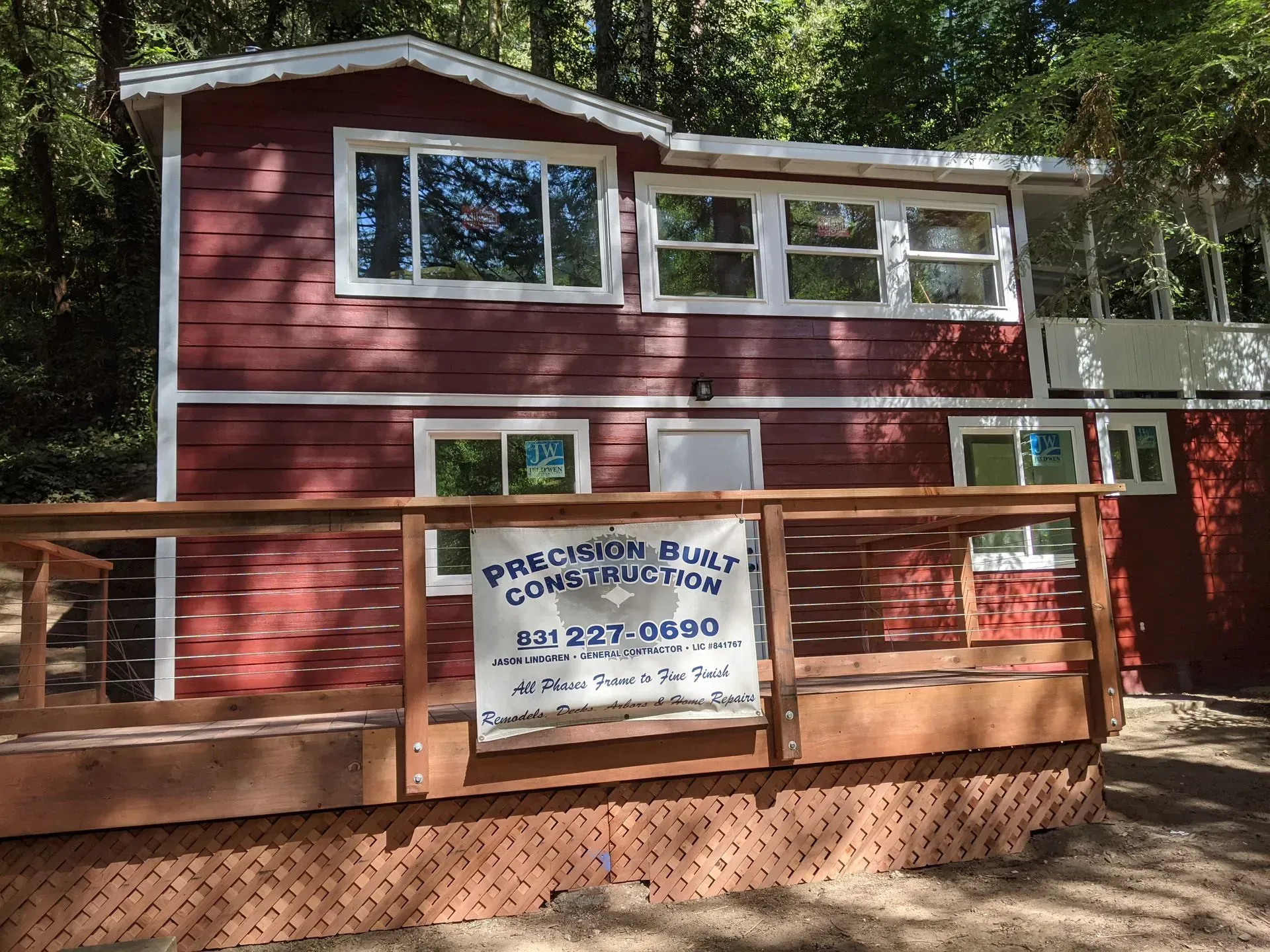 Red building with a sign reading “Brookside Pub” and a wooden ramp in front