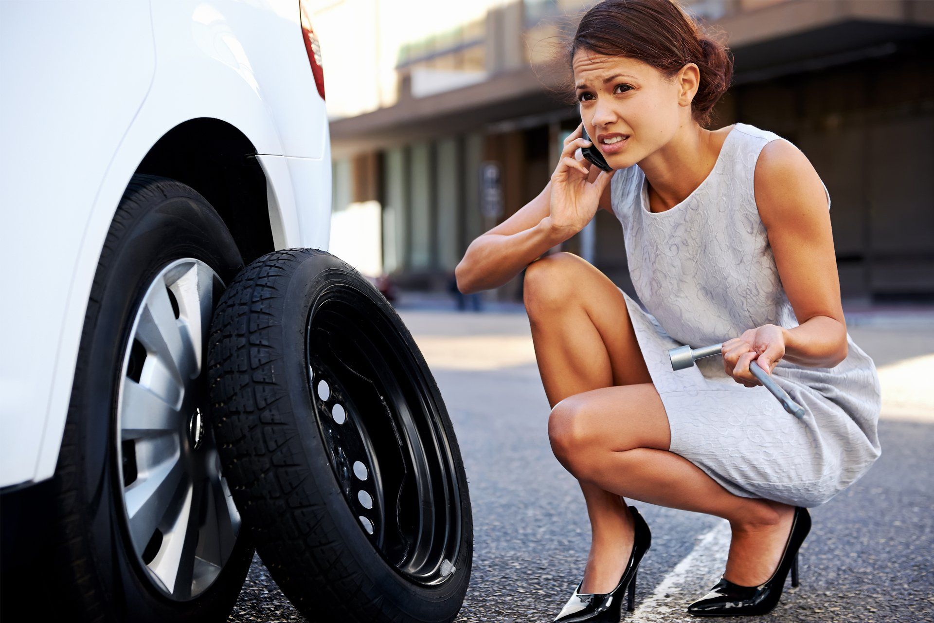 Woman Calling for Help to Change Her Car Tire