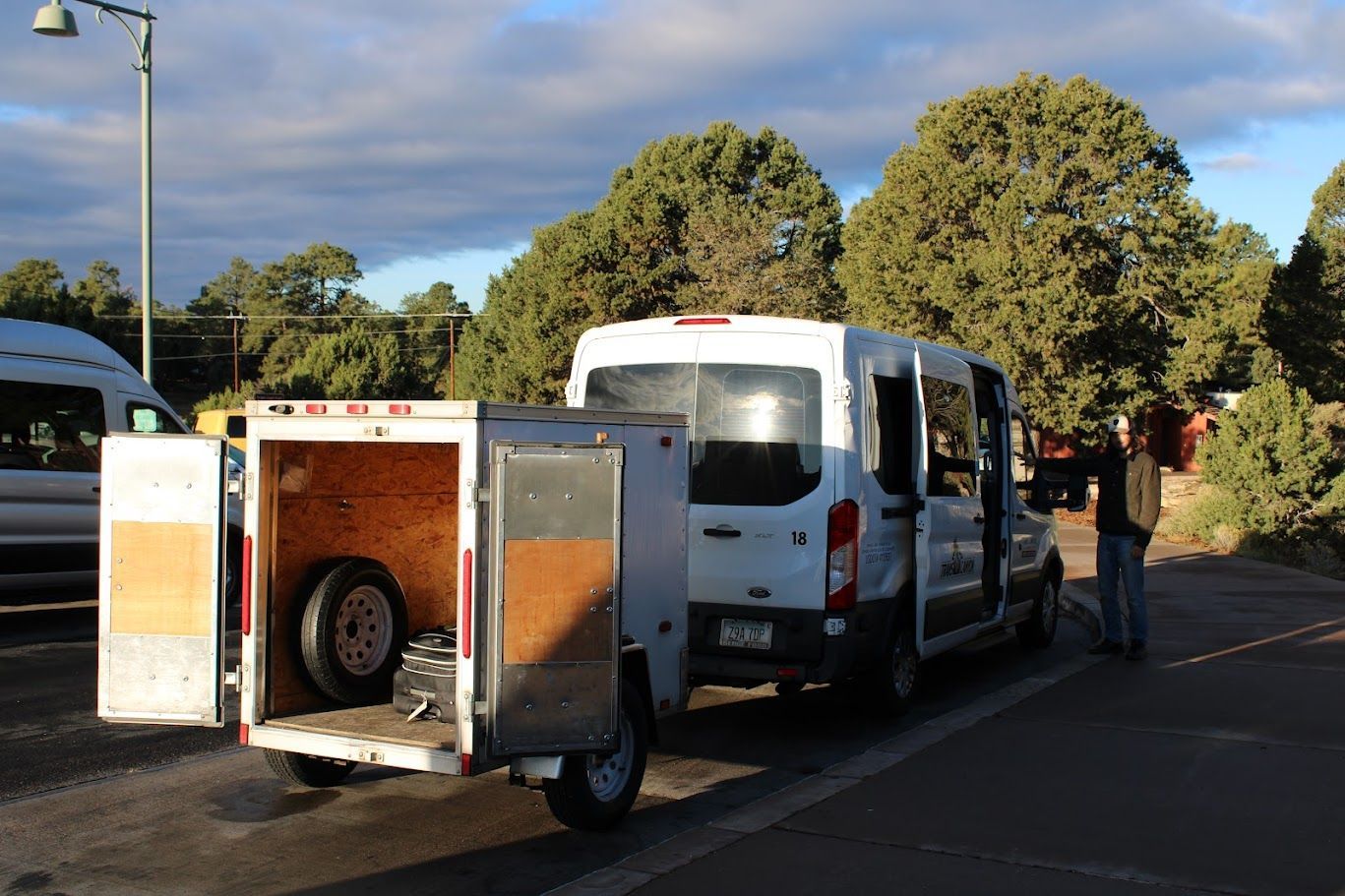 A white van with a trailer attached to it