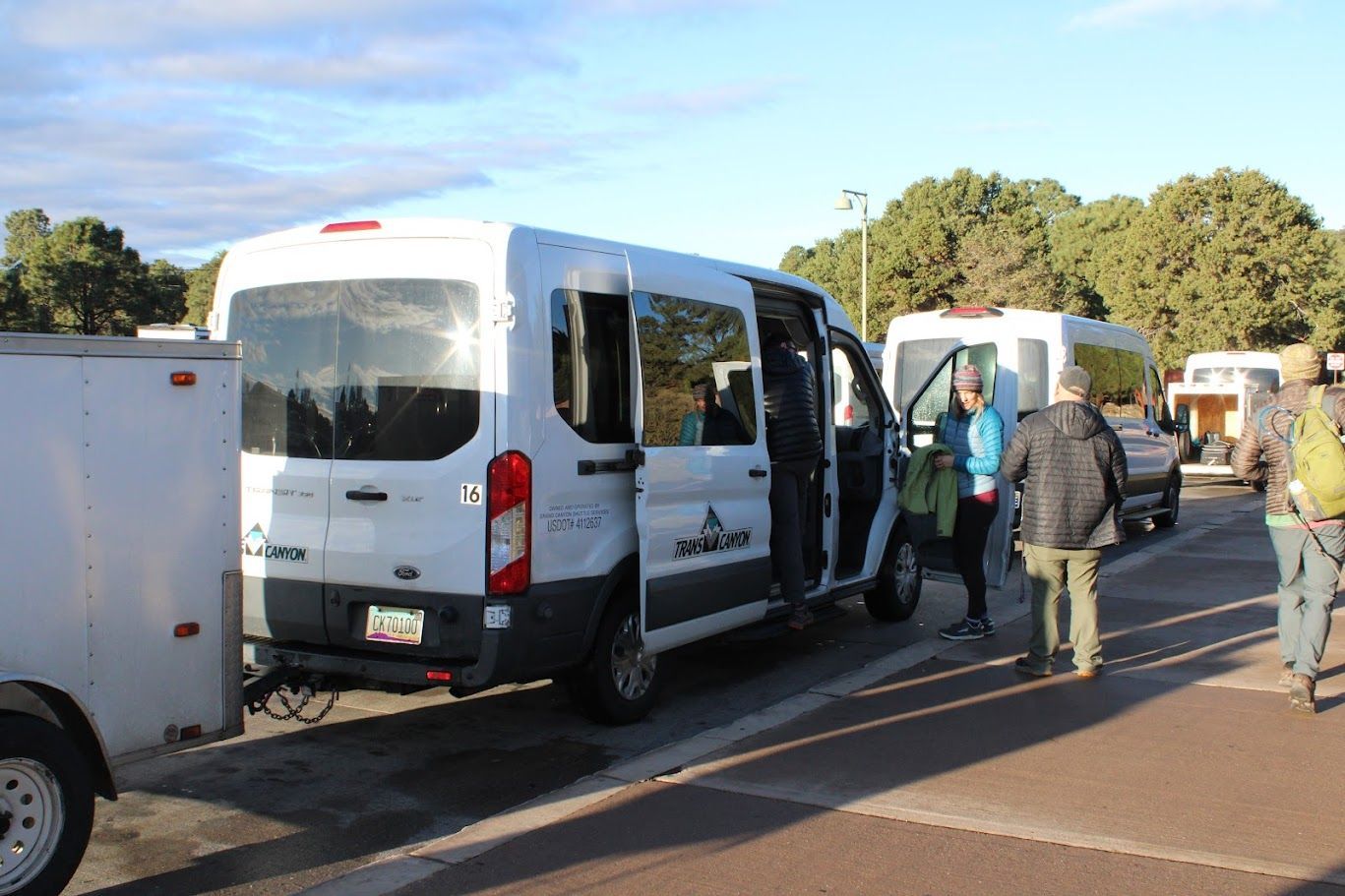 A group of people are getting out of a white van.