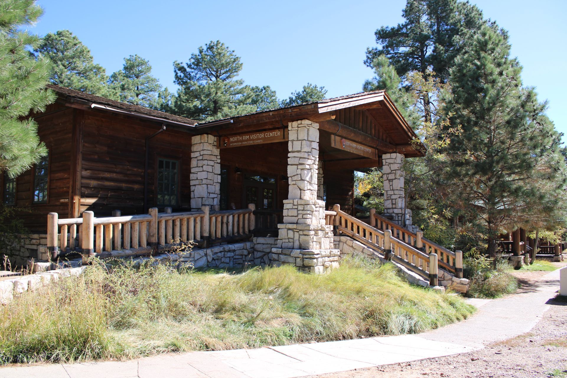A log cabin with a stone porch and stairs