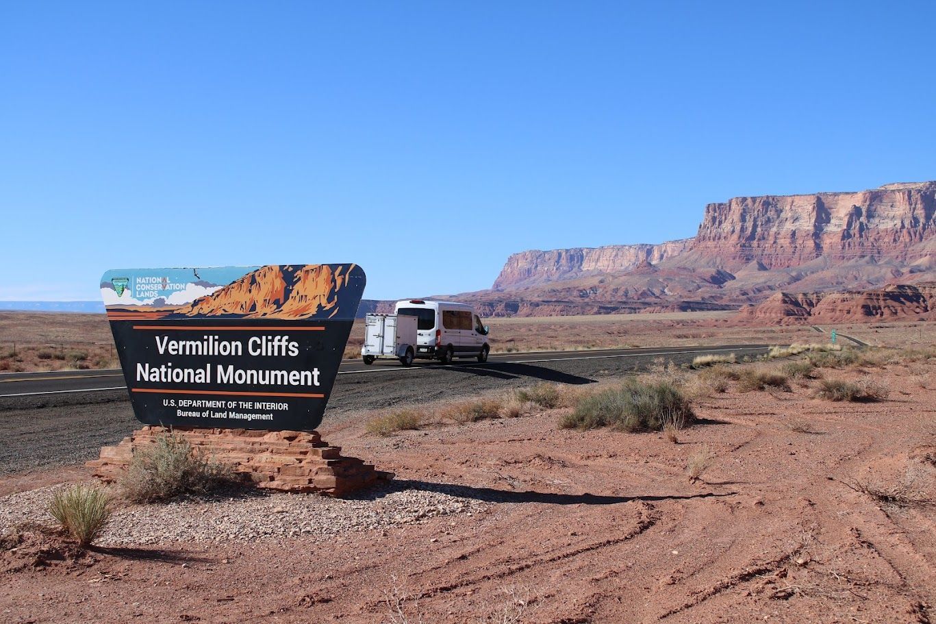 A sign for vermillion cliffs national monument in the desert