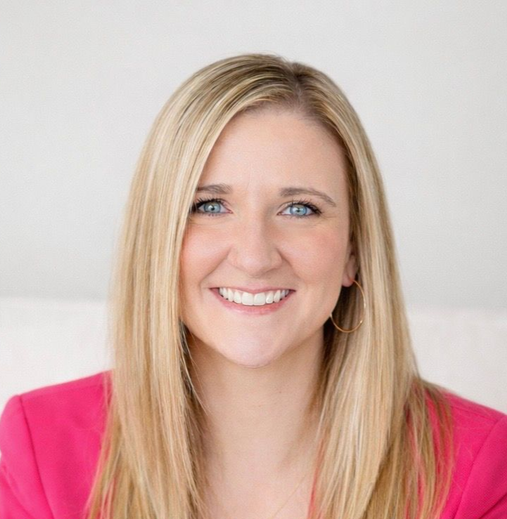 Smiling blonde woman in a bright pink top against a light background