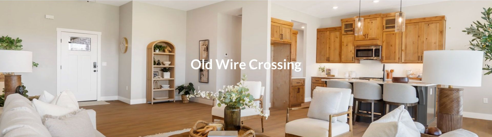 Open-plan living room and kitchen with beige decor and hardwood floors, labeled “Old Wire Crossing”