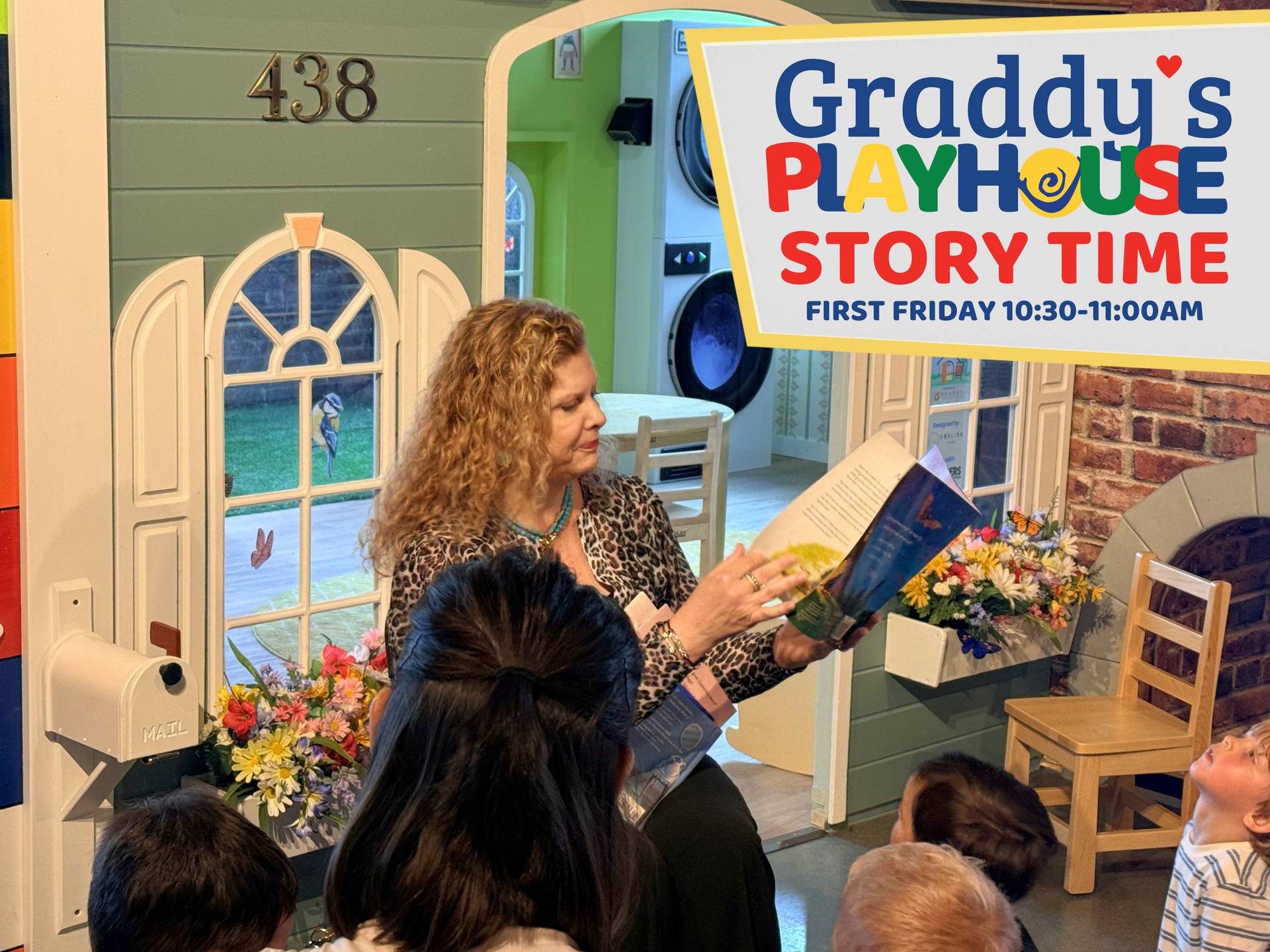 Woman reads to children at Graddy's Playhouse Story Time event indoors.