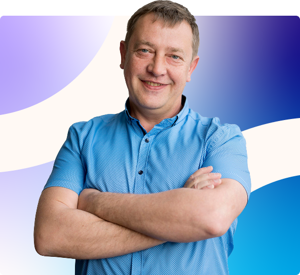 Smiling man in a blue shirt with arms crossed against a purple-to-blue gradient background