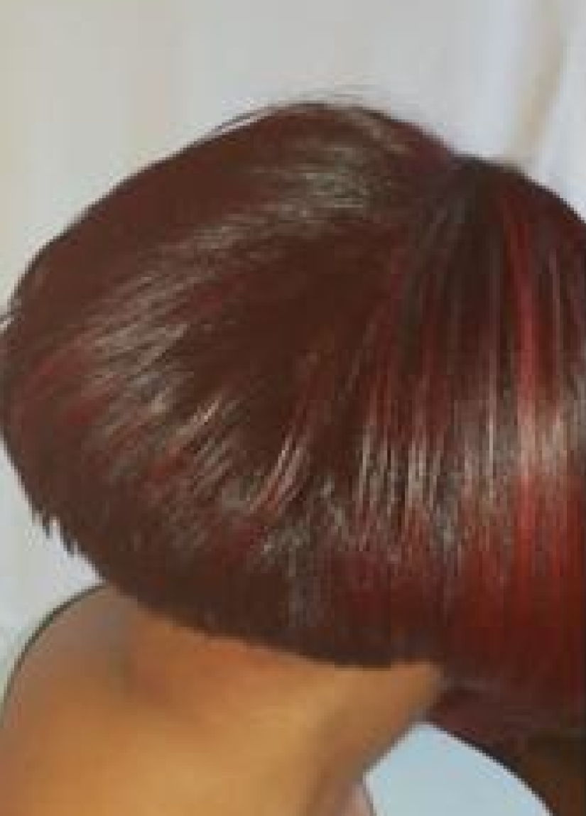 Short dark red bob haircut with a rounded, layered shape and shiny highlights