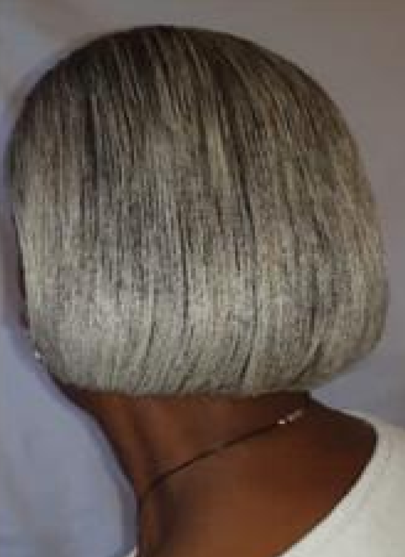 Close-up of a short silver-gray bob haircut viewed from the back.