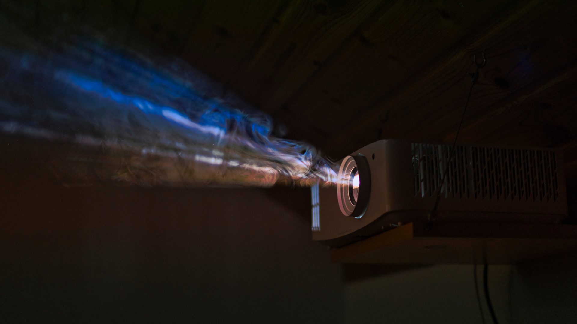 A close up of a camera lens with a light coming out of it
