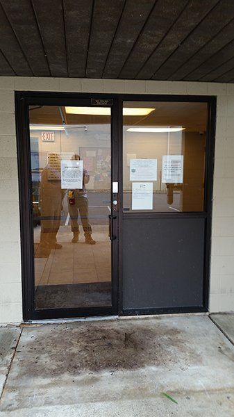 A person is standing in the doorway of a building.