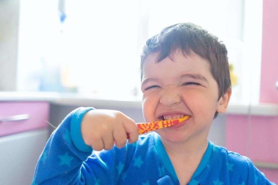 Smiling child brushing teeth with a colorful toothbrush in a bright bathroom