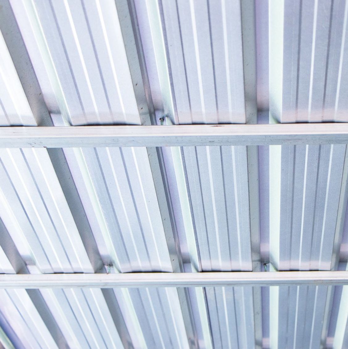 A close up of a metal roof with a metal frame.