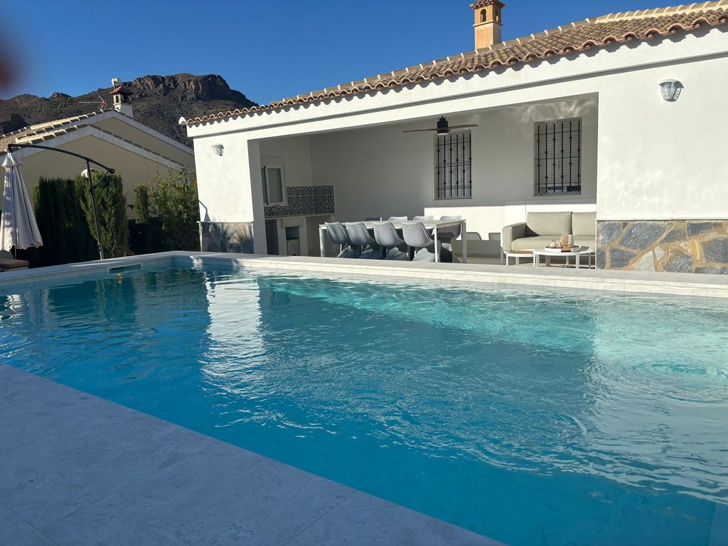 pool and porch with lounge and dining table