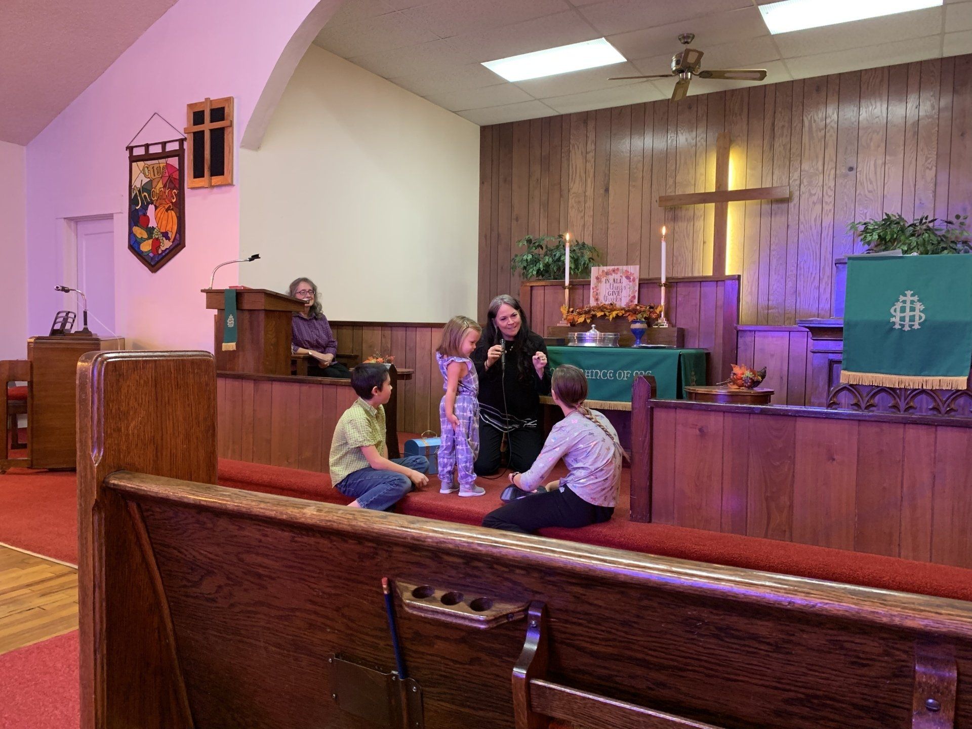 A group of children are sitting in a church.