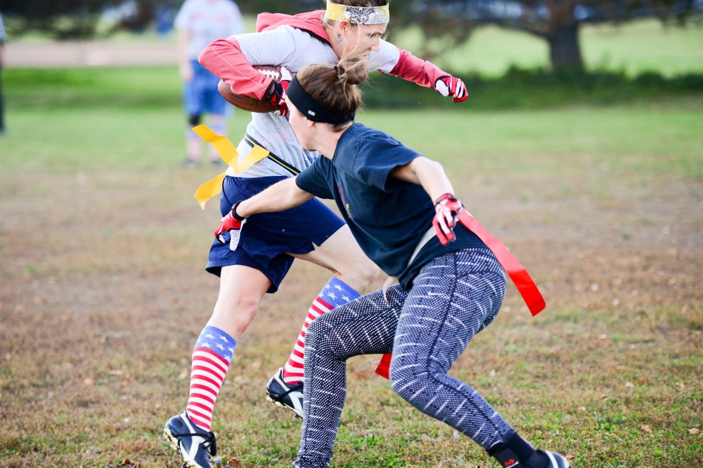 Basketball game: Referee handing ball to smiling player as opponent looks on.