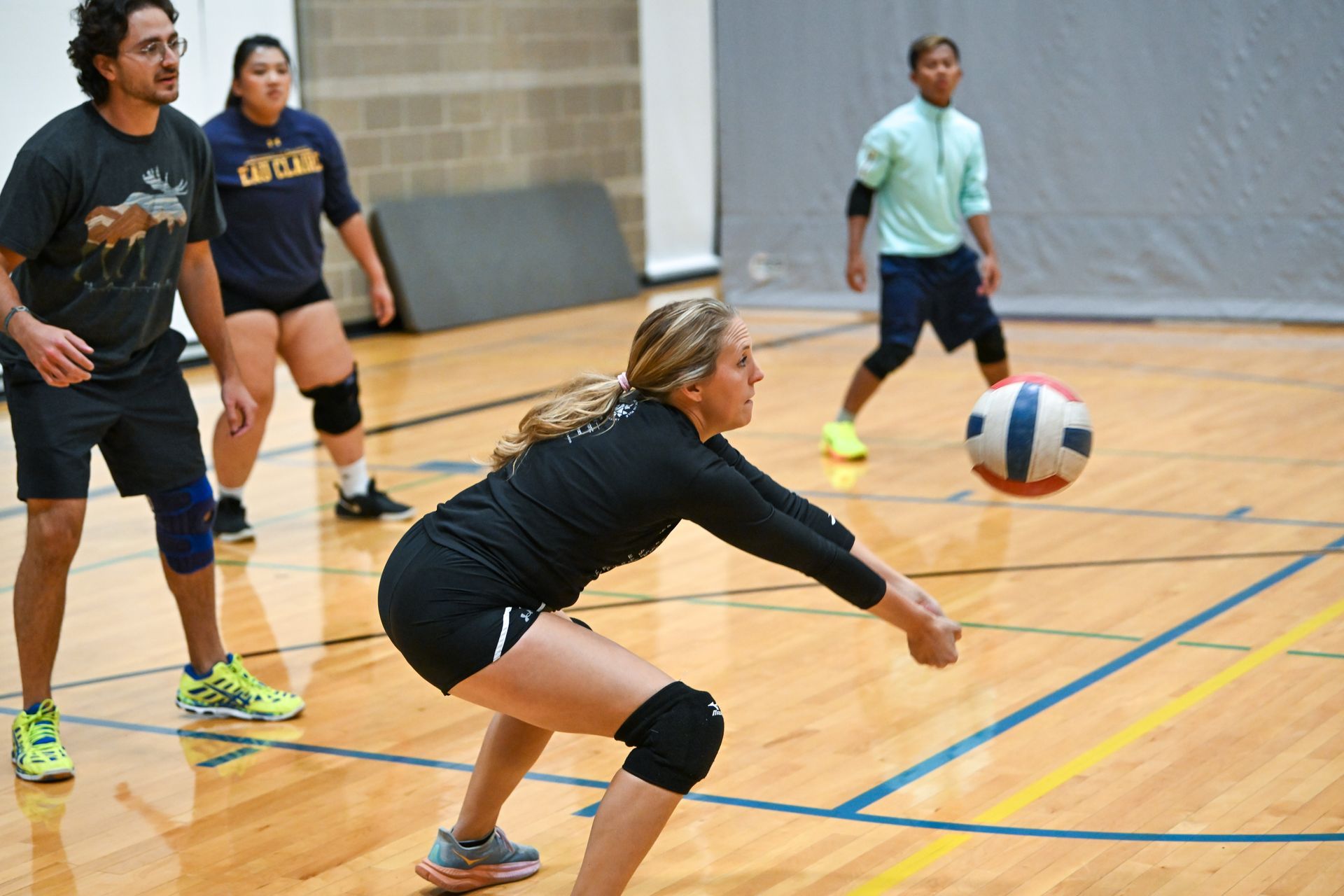 Basketball game: Referee handing ball to smiling player as opponent looks on.