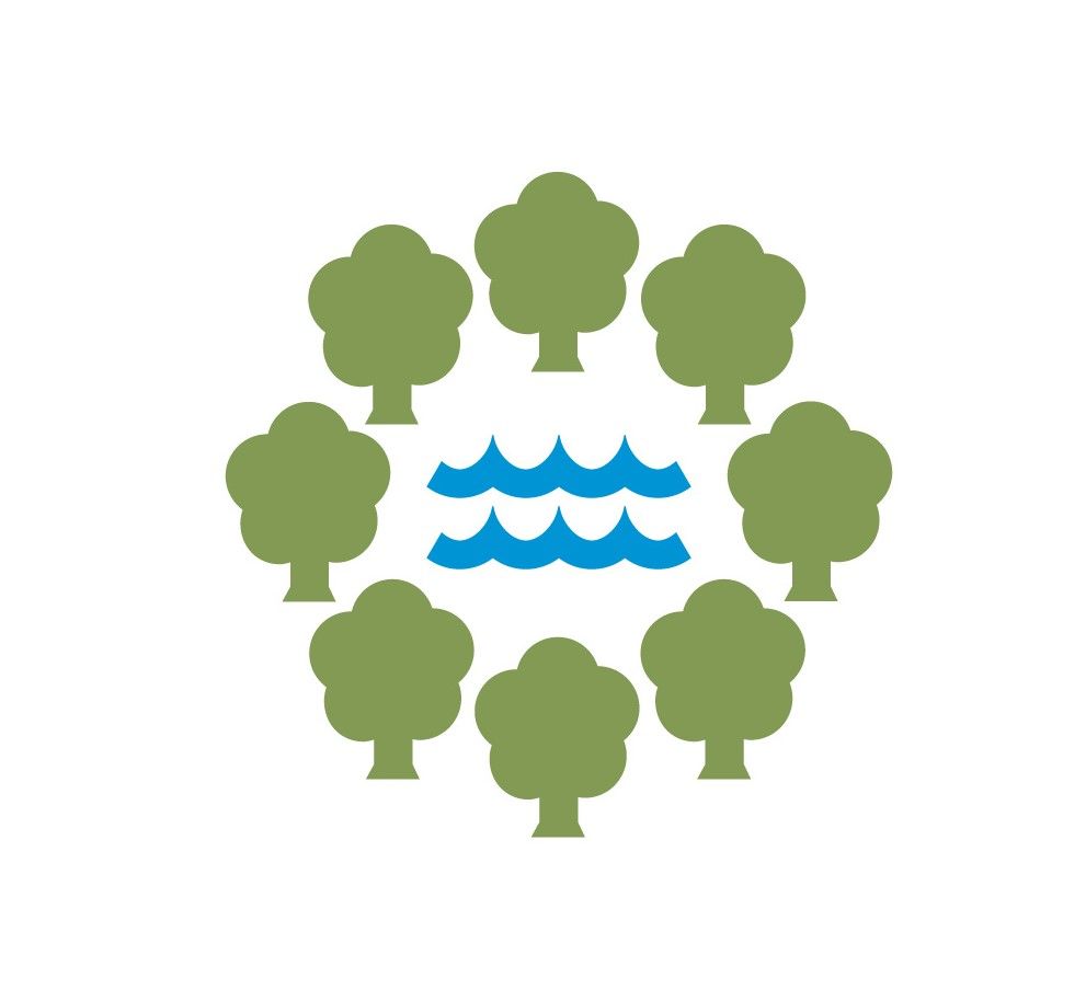 Circle of green trees surrounding blue water waves.