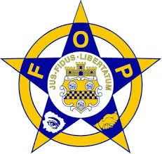 Blue and gold star emblem with a central crest and the text “US-JUDOS-LIBERTY” around it.