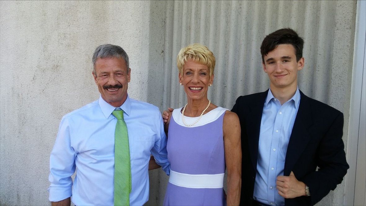 A family of three smiling. A family of three smiling.