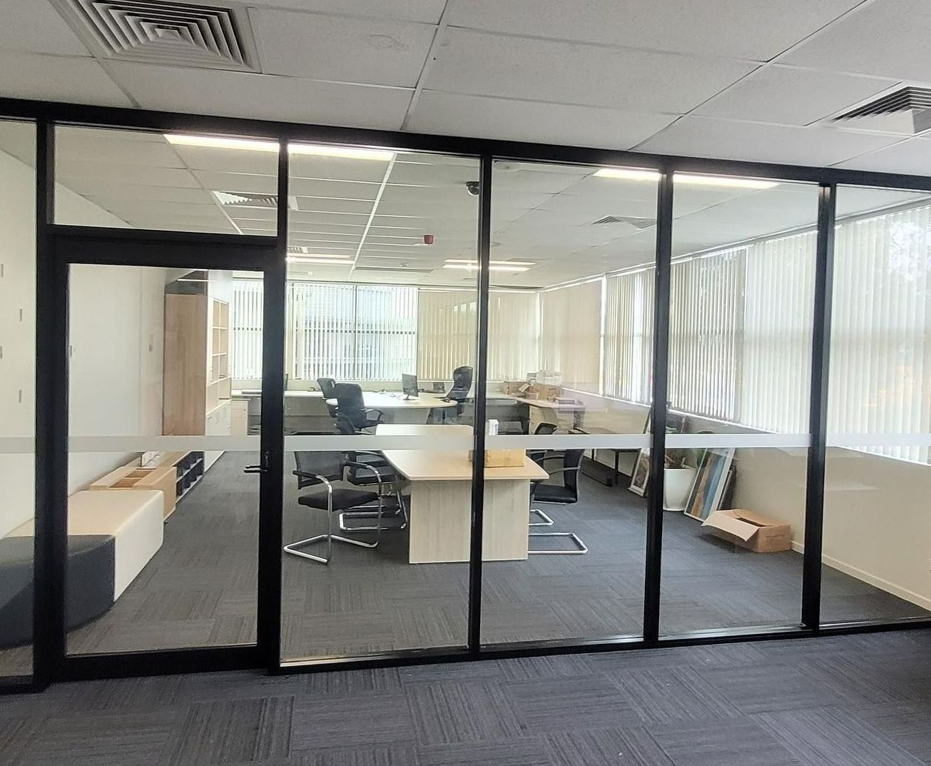 A Large Office With a Lot of Windows and Tables and Chairs — Tuggerah Lakes Glass In Tuggerah, NSW