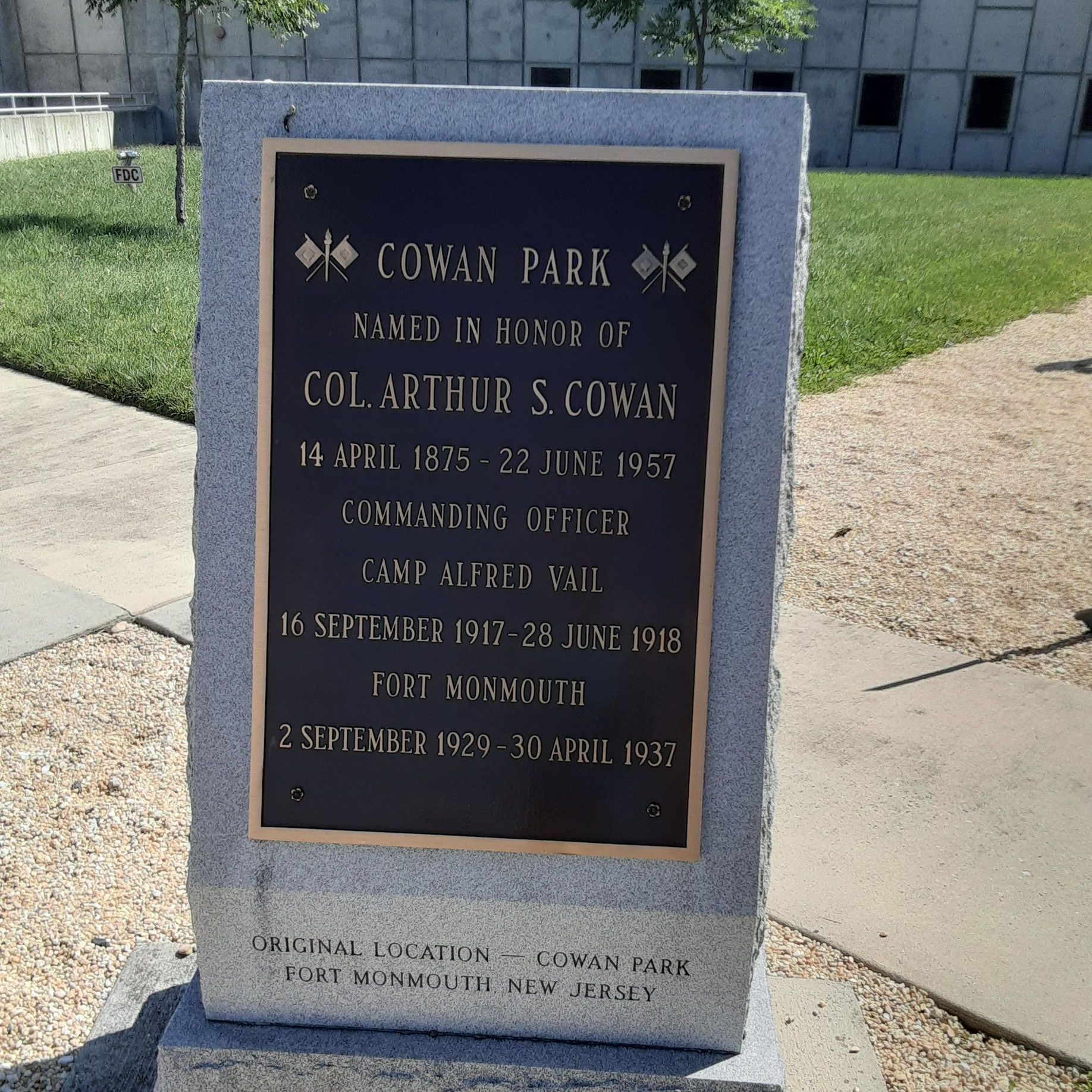 Memorial plaque for Col. Arthur S. Cowan in Cowan Park, Fort Monmouth, New Jersey. Brown text on a bronze plaque.