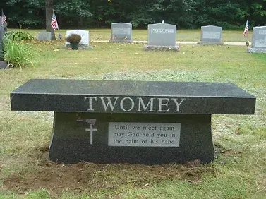 Black granite bench in a cemetery with the name