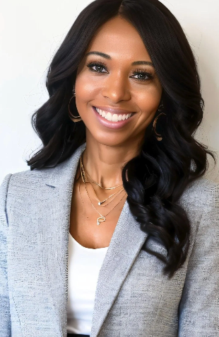 Smiling woman in a light gray blazer and white top against a plain white background
