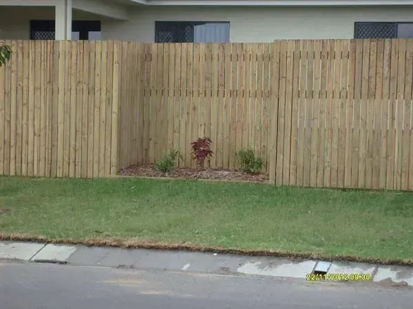 Wooden Privacy Fence Behind a Small Patch of Grass Along a Residential Street — Fencing Around in Garbutt, QLD