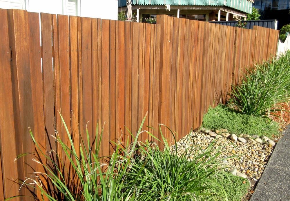 Wooden Fence Beside a Gravel Path With Tall Grass and Green Shrubs — Fencing Around in Garbutt, QLD