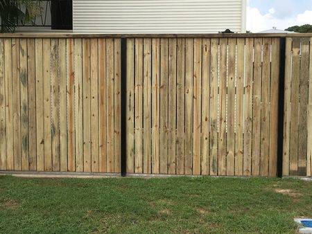 Wooden Privacy Fence With Vertical Slats Along a Grassy Yard — Fencing Around in Garbutt, QLD