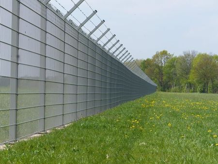 Long Metal Fence Beside a Grassy Field With Trees in the Background — Fencing Around in Garbutt, QLD