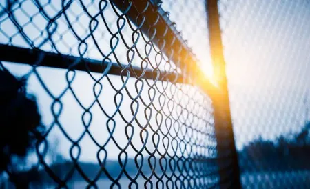 Sunlight Shining Through a Chain-link Fence at Dusk — Fencing Around in Garbutt, QLD