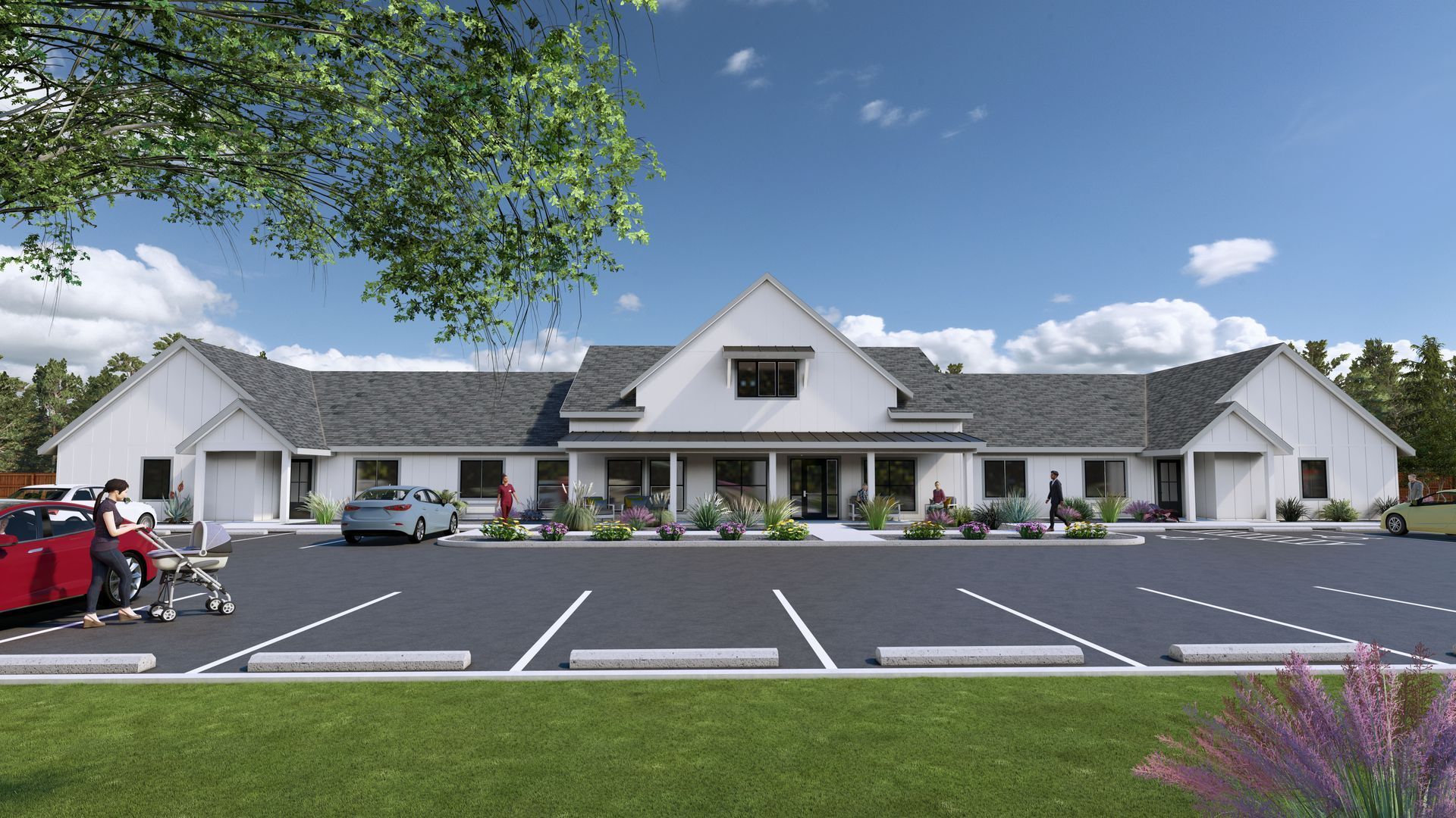 White building with peaked roof and parking lot under a blue sky, with trees and a red truck at left