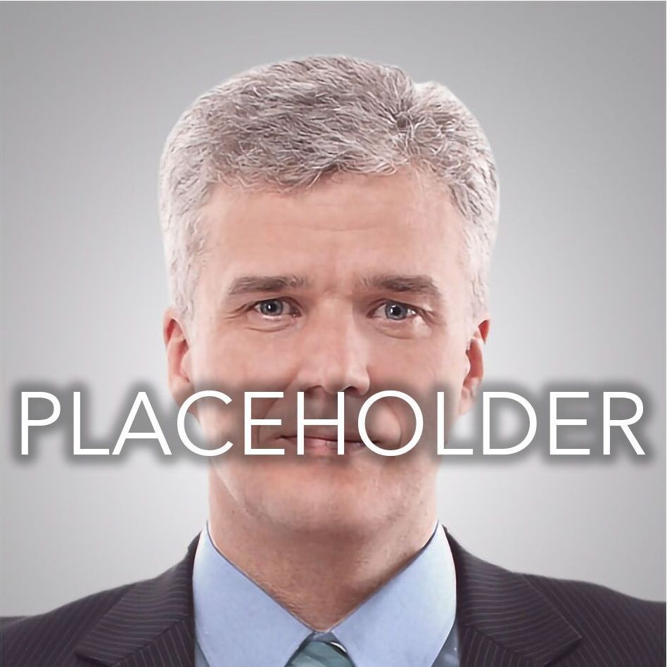 A man in a suit and tie with the word placeholder behind him