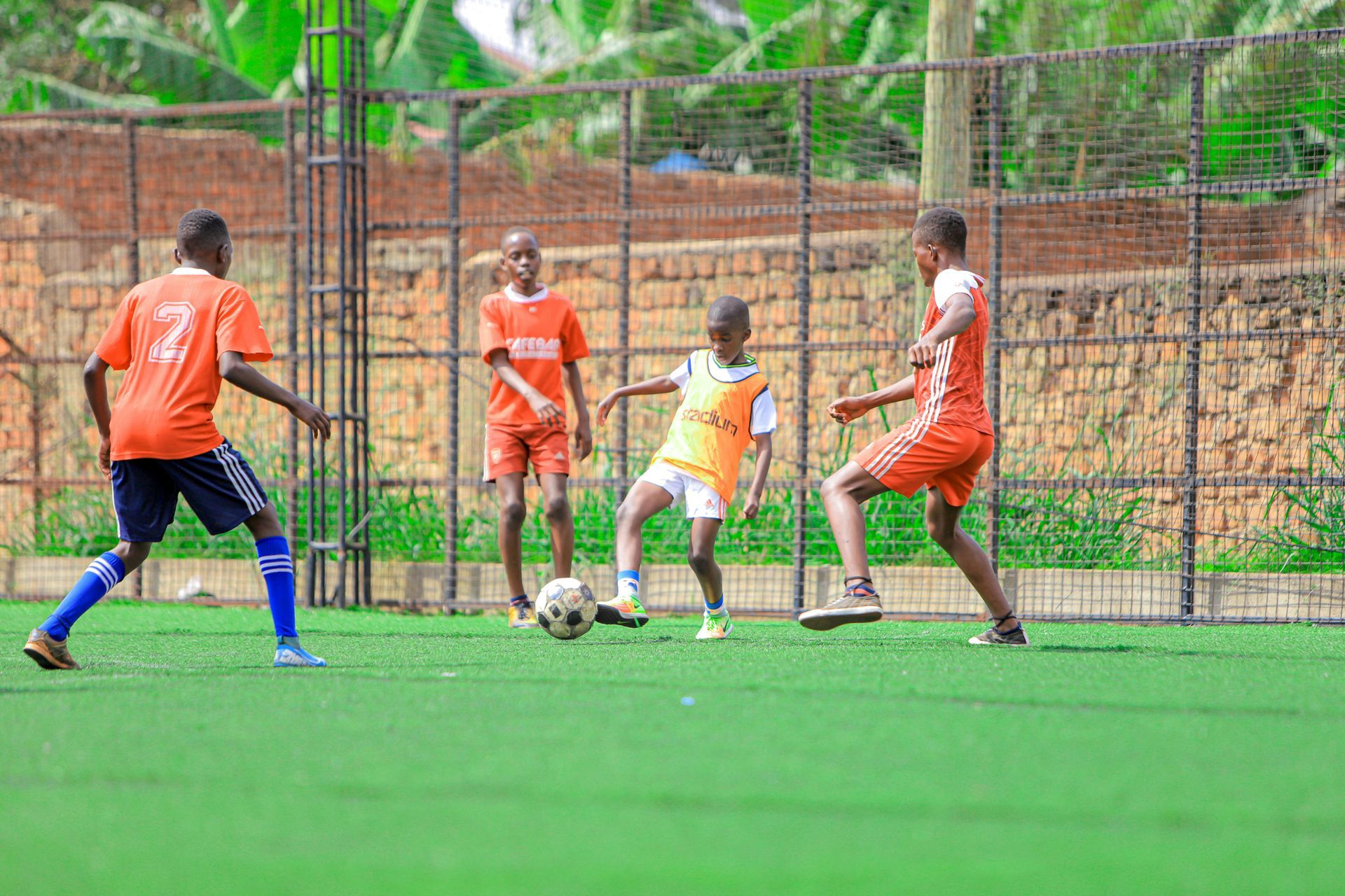 A group of young boys are playing soccer on a field.