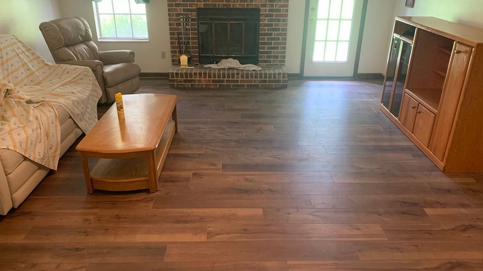 A living room with hardwood floors and a fireplace.
