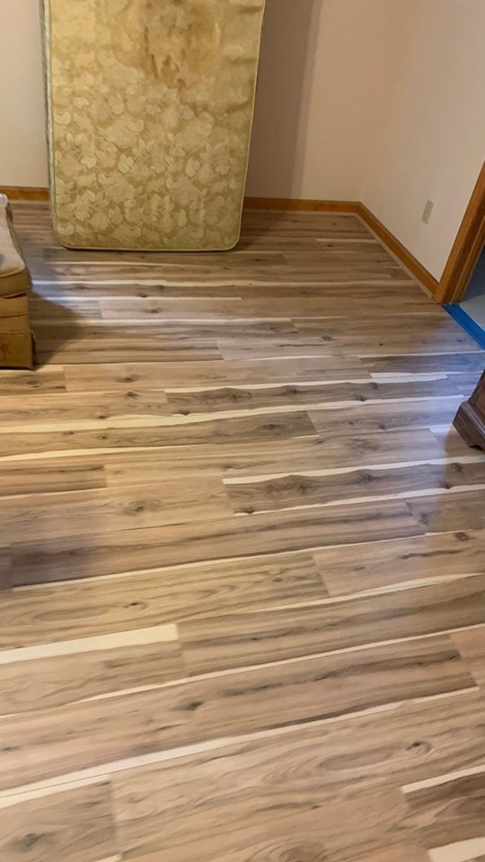 A mattress is sitting on a wooden floor in a room.