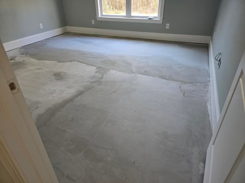 A room with a concrete floor and a window.