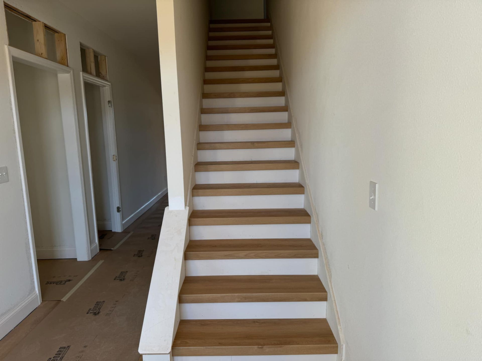 A set of wooden stairs leading up to the second floor of a house
