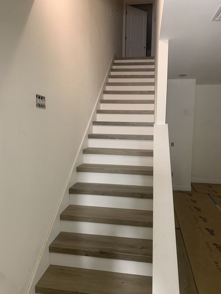 A set of stairs leading up to a door in a room.