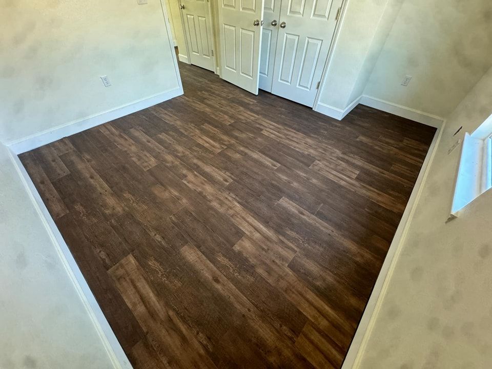 A room with a wooden floor and white walls.